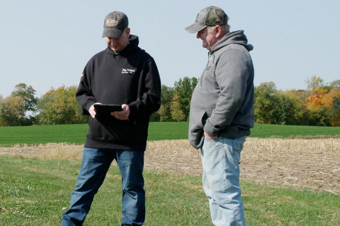 photo of two men on a farm with an ipad