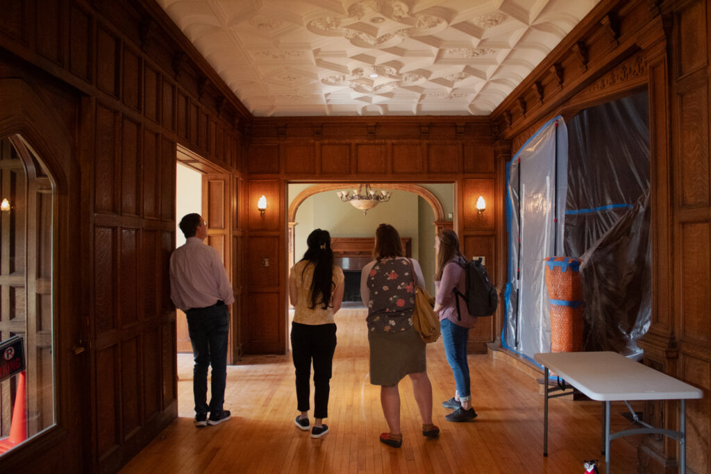 Four members of the Sustainable Growth Coalition stand in the entryway of Pillsbury Castle.