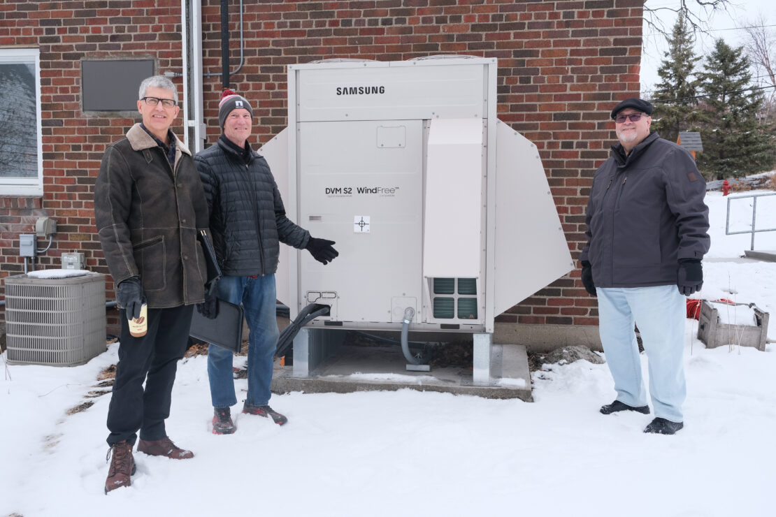 Cabrini staff poses in front of VRF system.